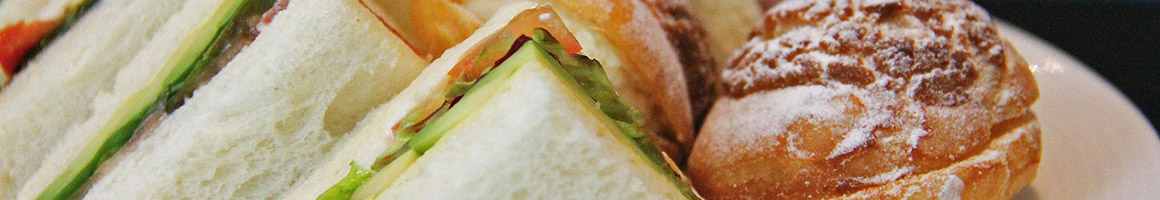 Eating Deli Sandwich at Omega Deli & Cheese Company restaurant in Buffalo, NY.